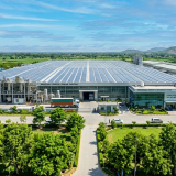 A modern eco-friendly factory in Pakistan featuring industrial solar panels on the roof